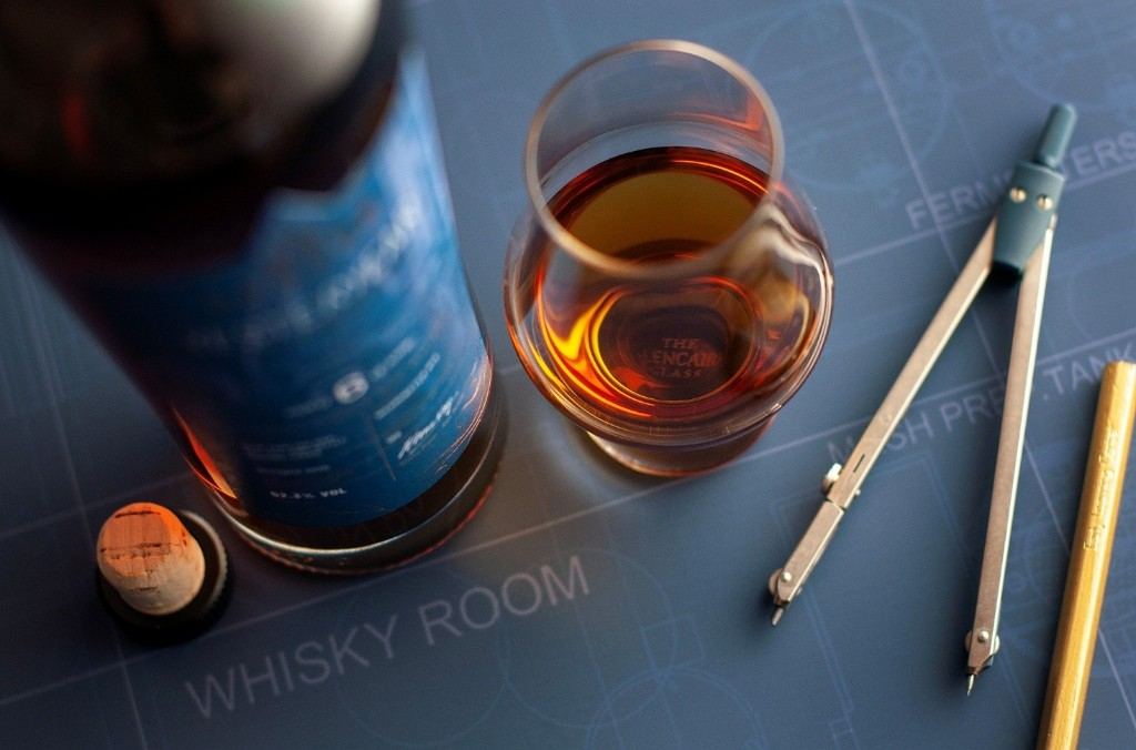 Yesteryear whisky glass and bottle on a whisky room blueprint