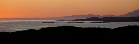 Scenic Island Seascape at Sunset - Breathtaking coastal view with mountains in the distance.
