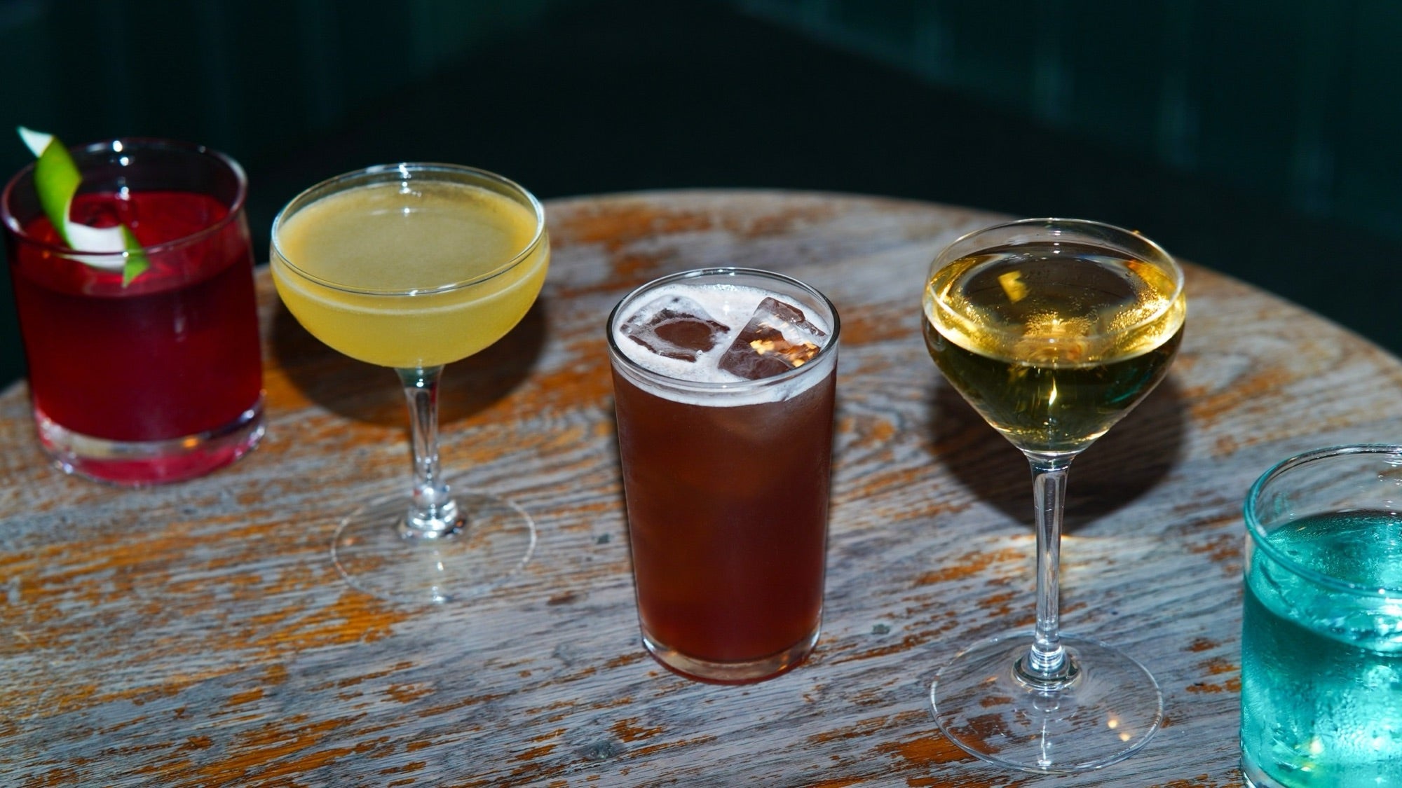 A flight of cocktails on a wooden table in The Vault