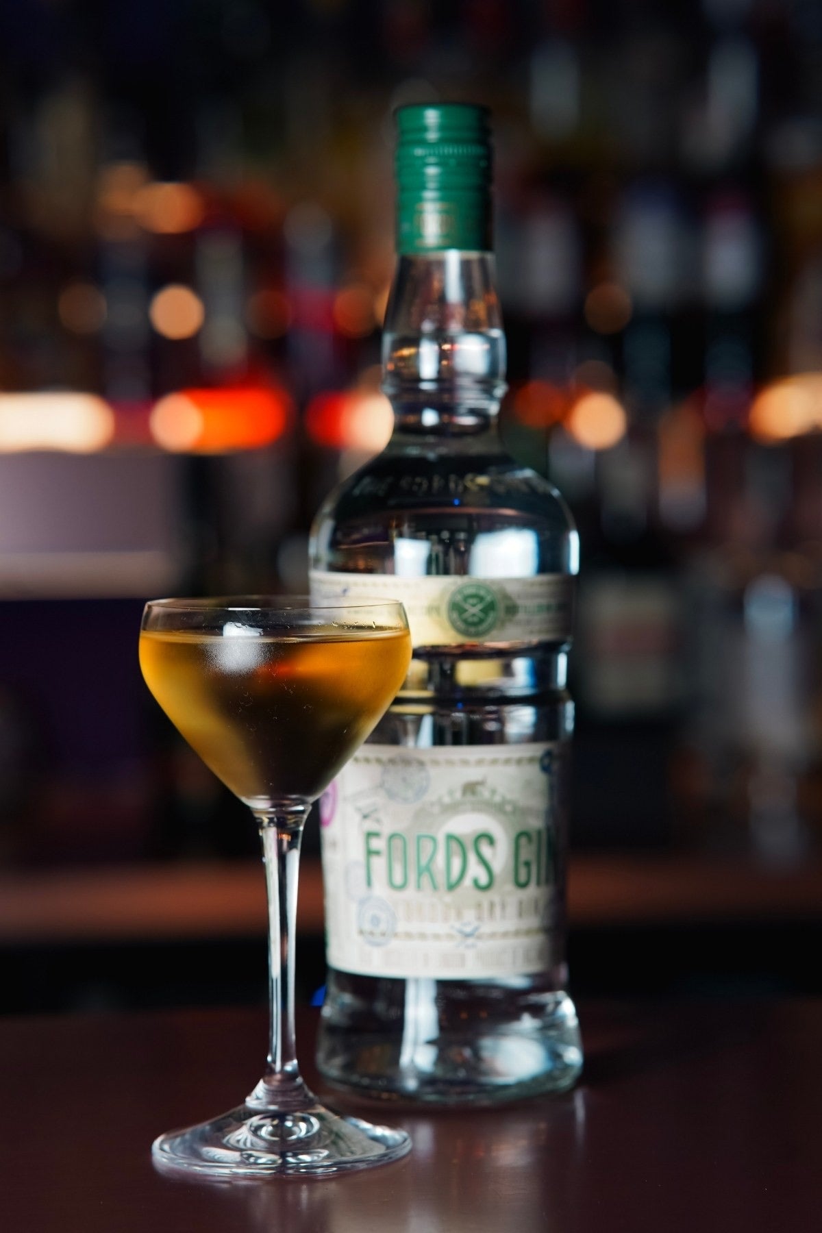 A gin cocktail beside the bottle in The Vault
