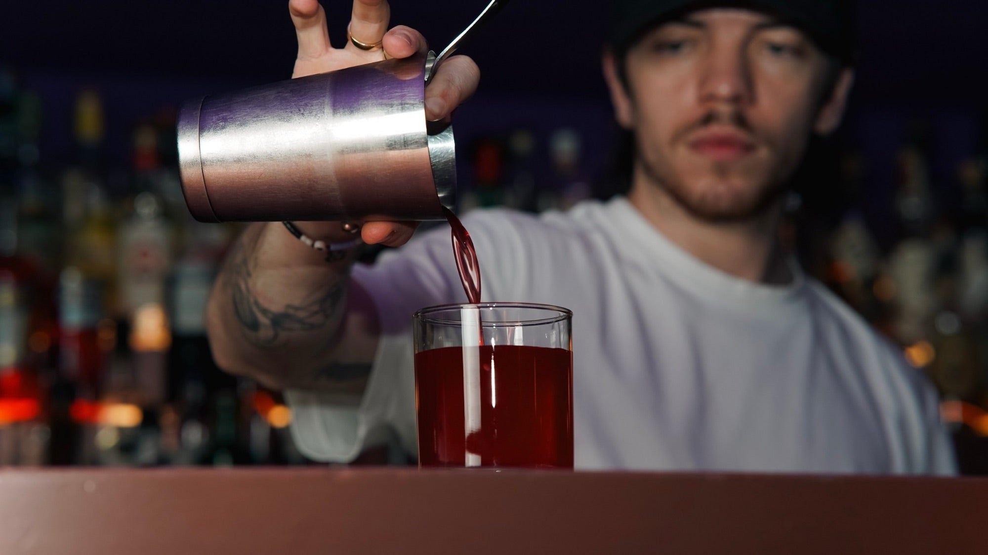 A bartender pouring a cocktail in The Vault