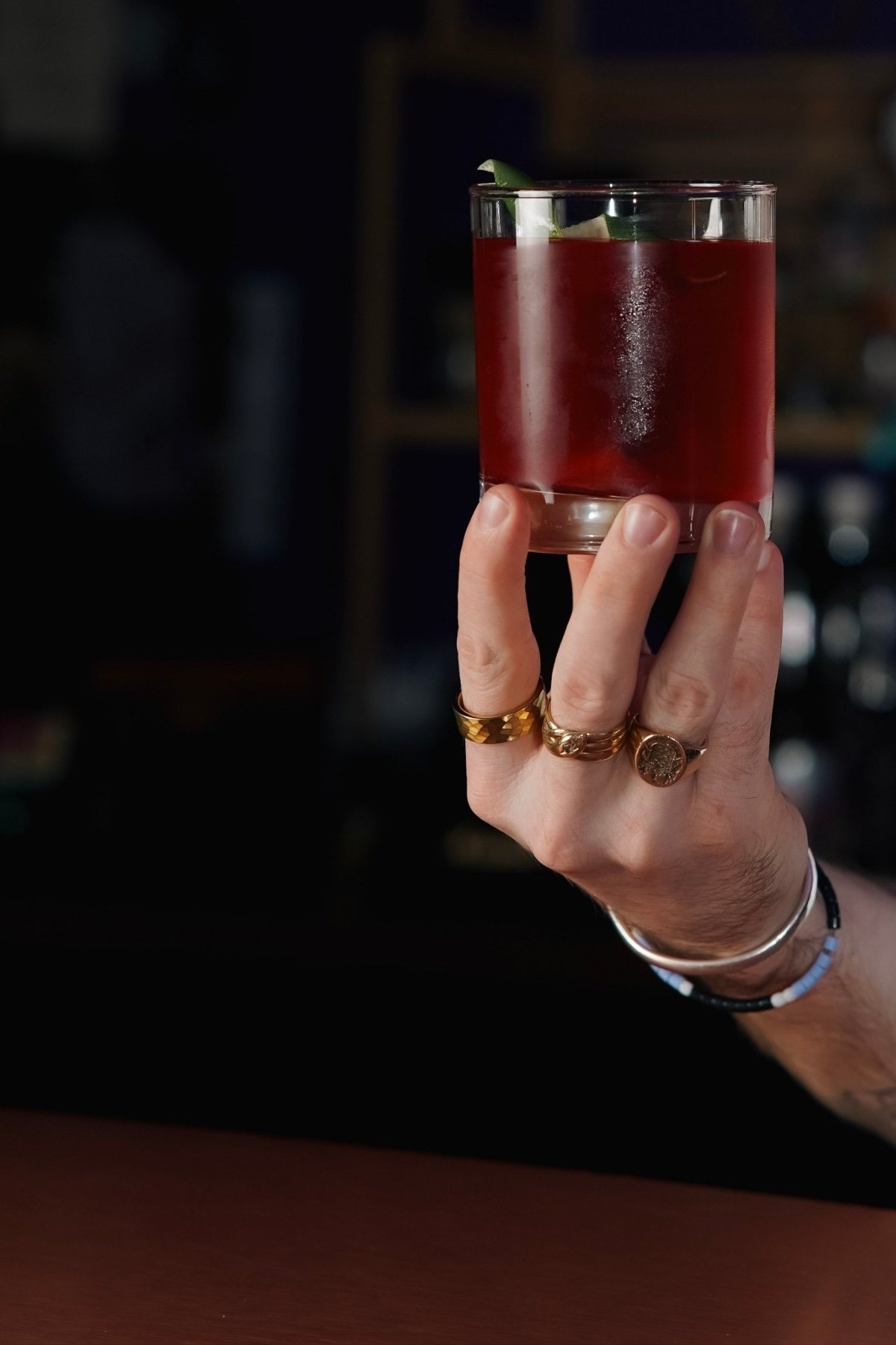 A red cocktail held at The Vault bar