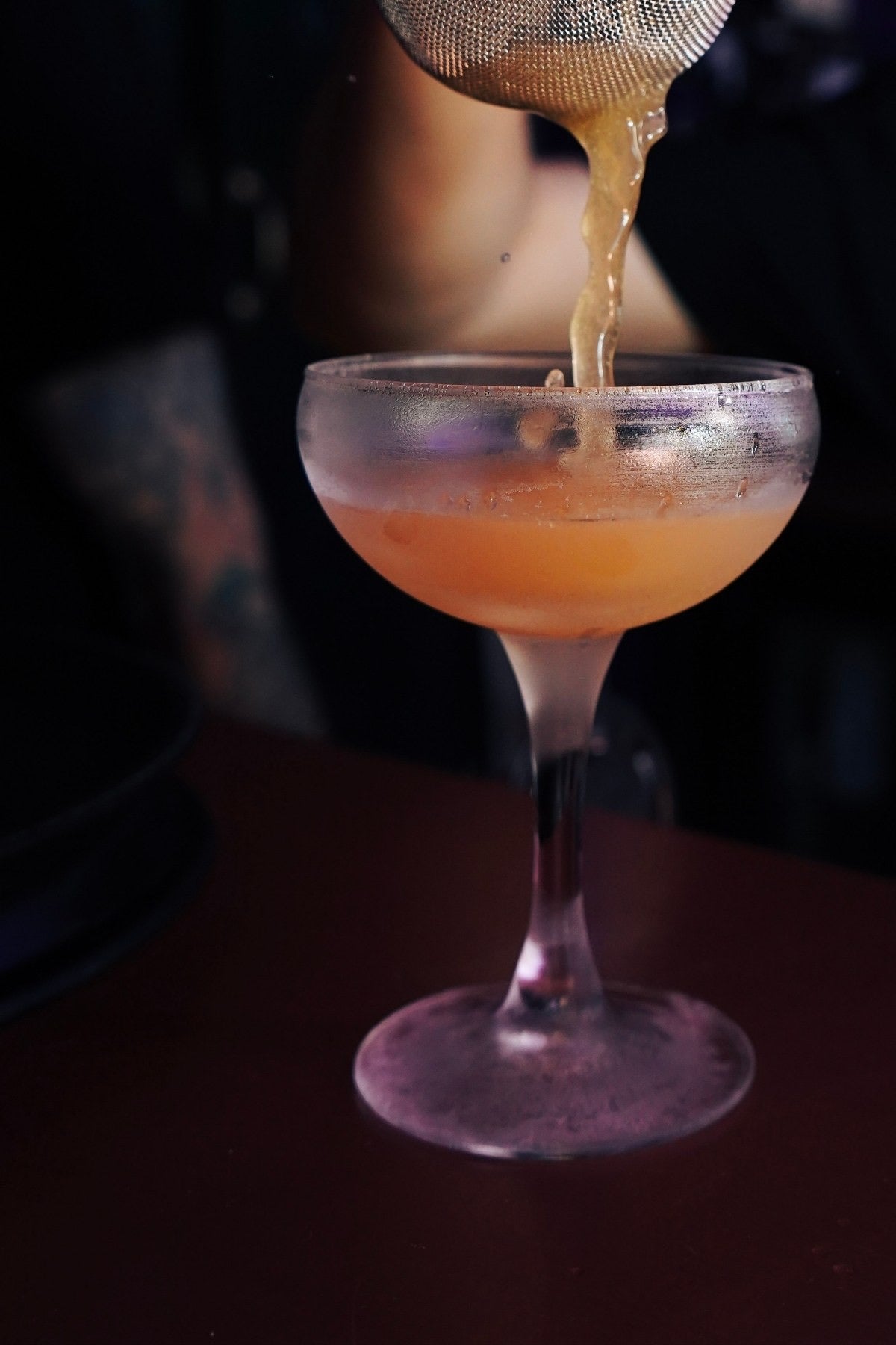 A cocktail strained into a coupe in The Vault